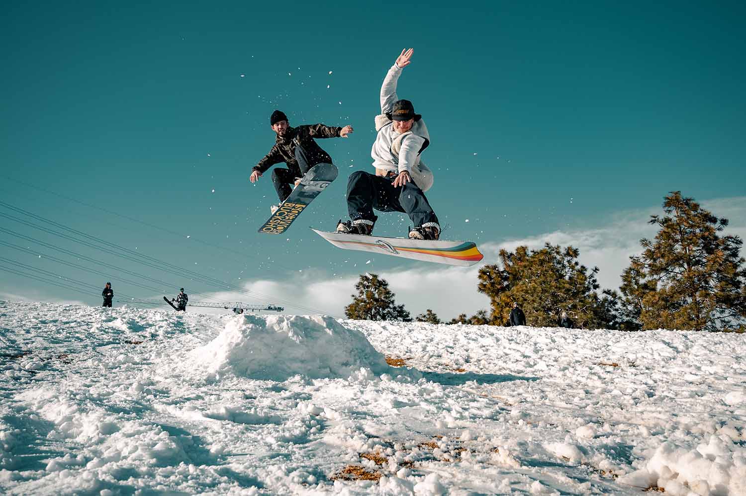 a person jumping in the air with snowboard